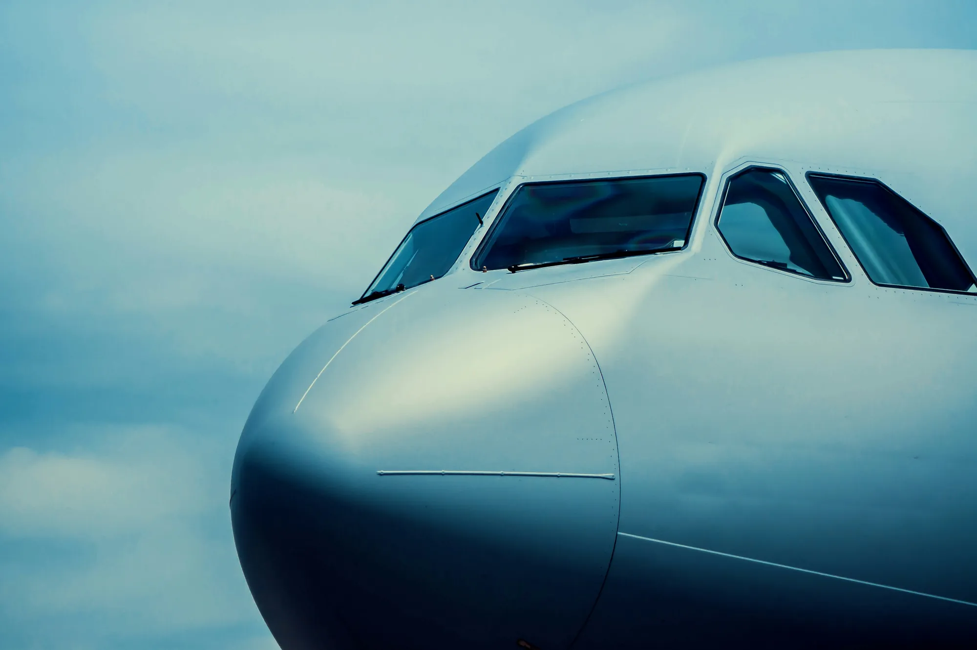The nose of an aircraft against open sky
