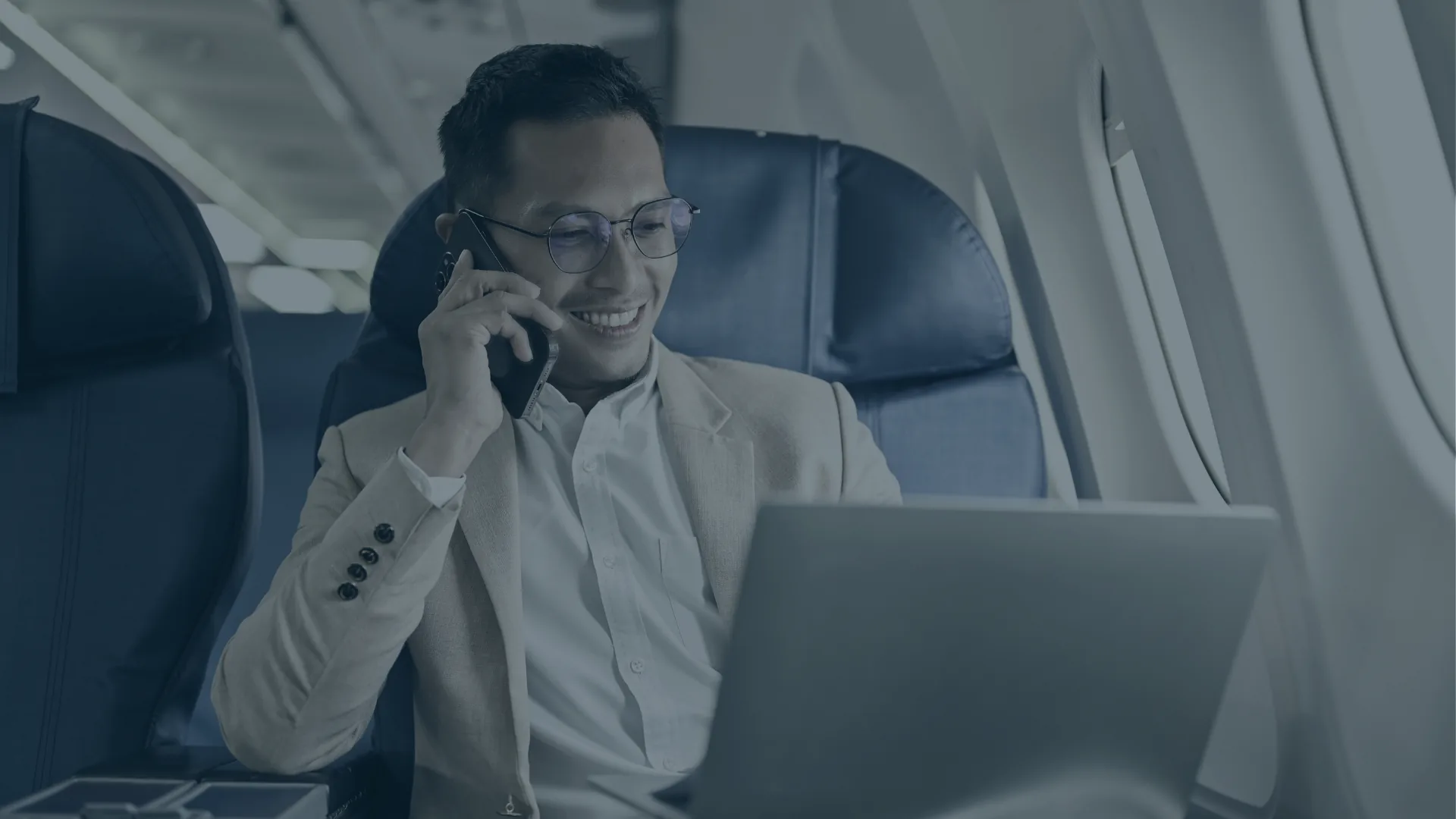A business traveller working from an aircraft cabin